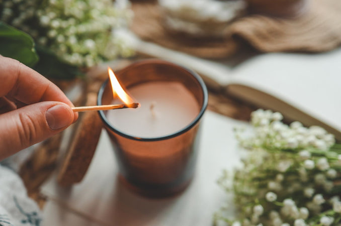 Woman lighting a candle with a match