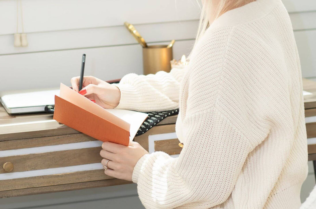 Woman writing in Copenhagen Journal about creating a year of hygge | Shop Hygge Box