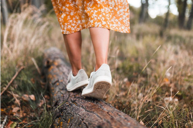 Woman's Feet Walking on a Log at the Forest