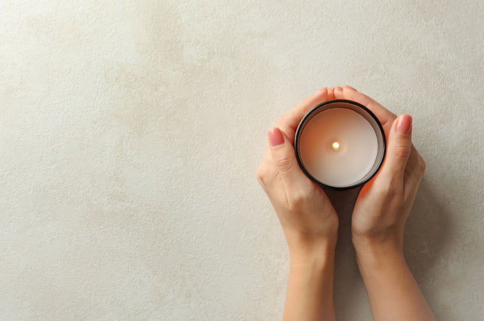 Woman hands wrapped around a candle | Easy Self-Care for Busy Lives Blog Post | Shop Hygge Box