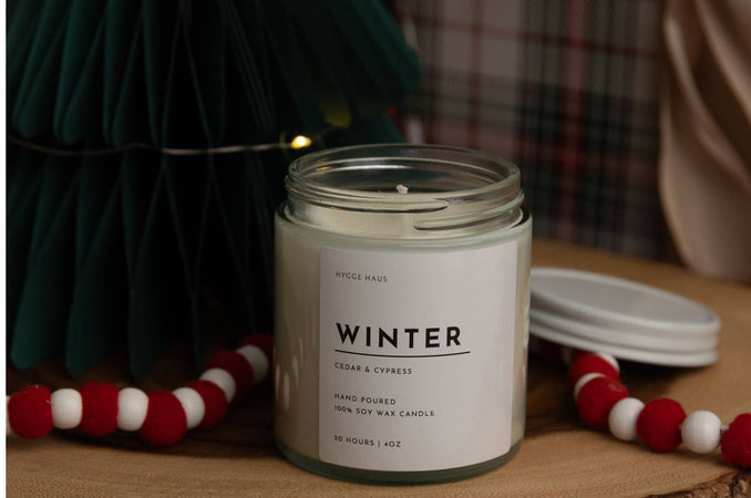 hygge haus winter candle on wooden board with holiday background