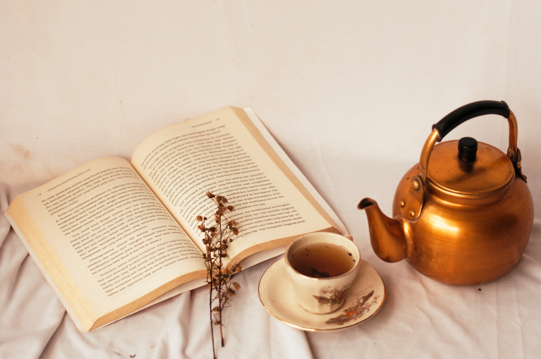 15 Books for Hygge Inspiration - Copper kettle with open book and a tea cup