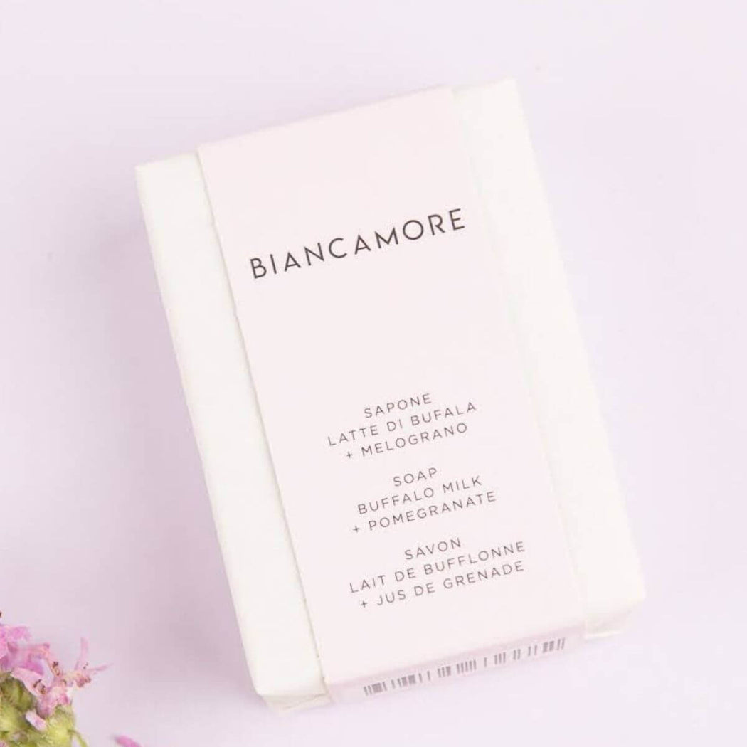 Biancamore buffalo milk and pomegranate soap bar in minimalist white packaging on a lavender background