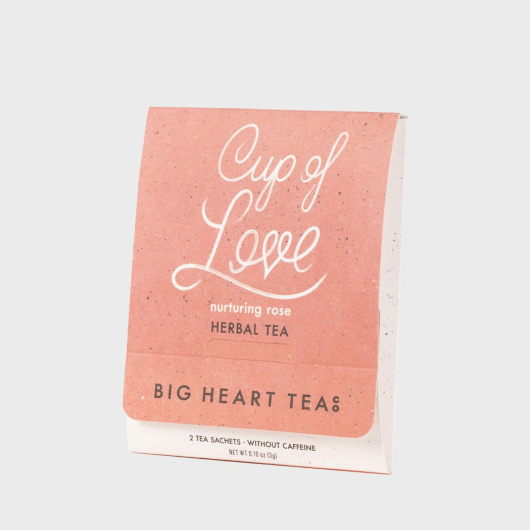 Tea package labeled 'Cup of Love' by Big Heart Tea on a light gray background