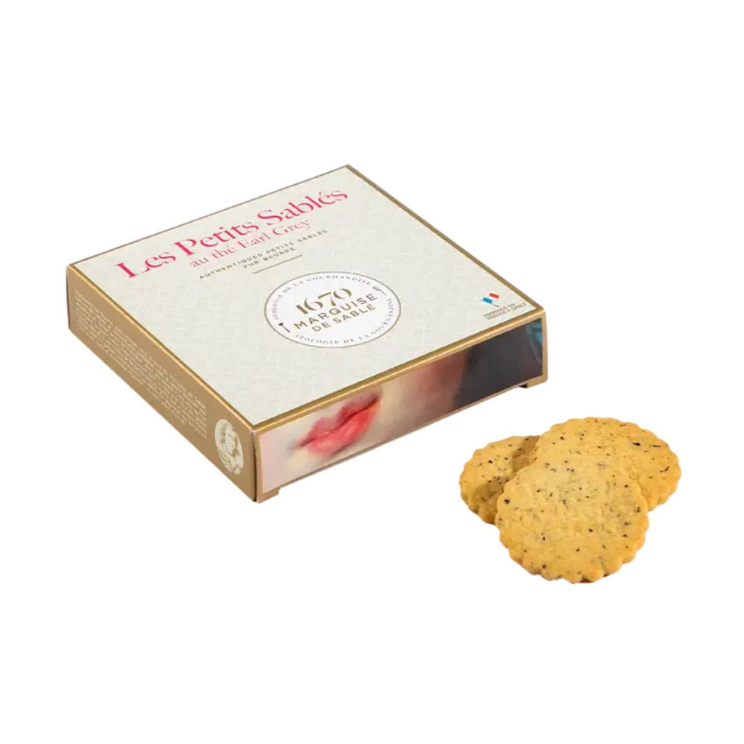 Box of 'Les Petits Sablés' Earl Grey Tea cookies with two cookies on a white background