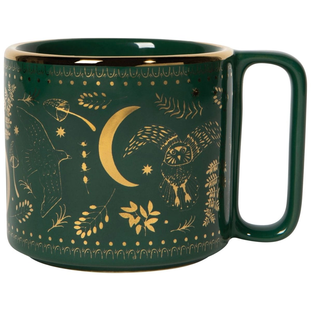 Green mug with gold celestial and nature-themed design on a white background