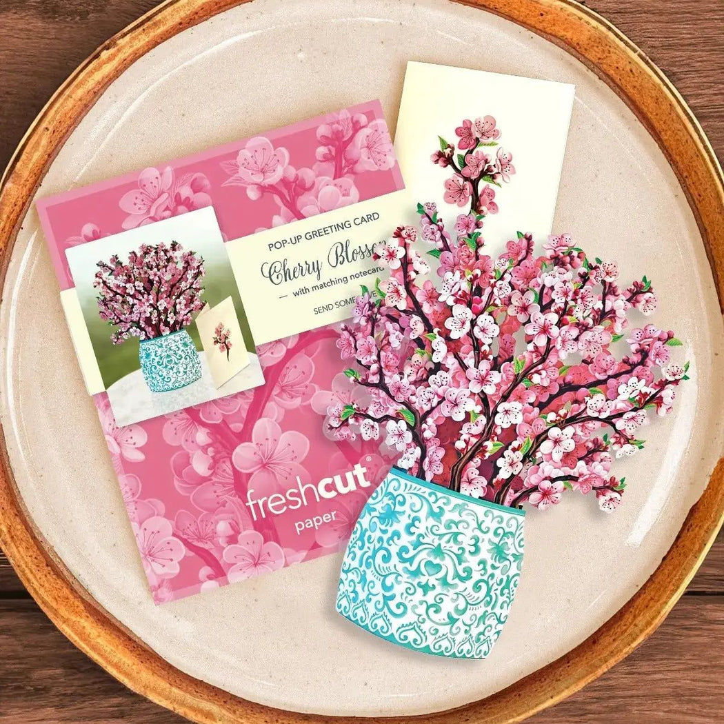 Cherry blossom-themed greeting cards and stationery on a plate