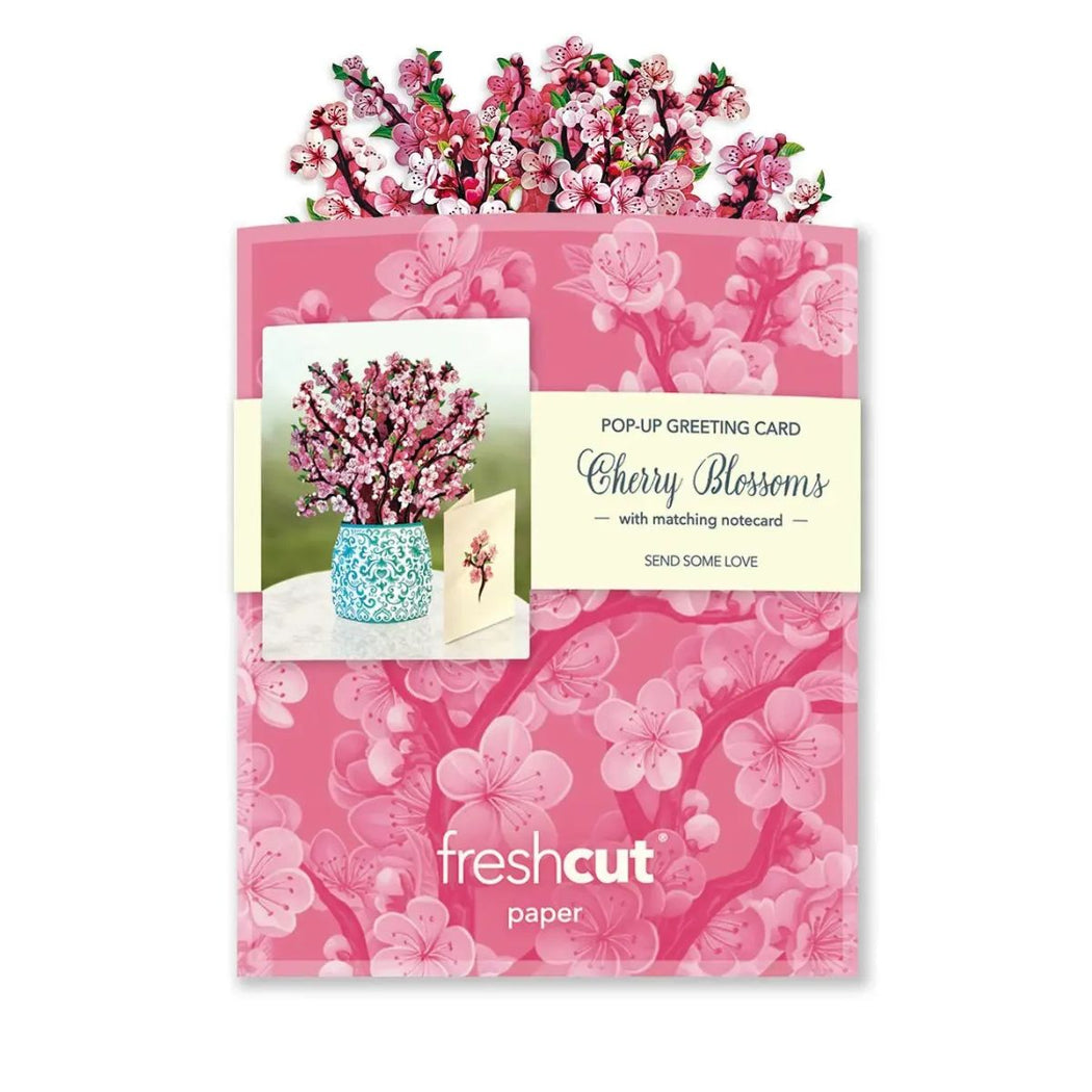 Pop-up greeting card with cherry blossoms and matching notecard on a pink floral background, featuring 'freshcut paper'.