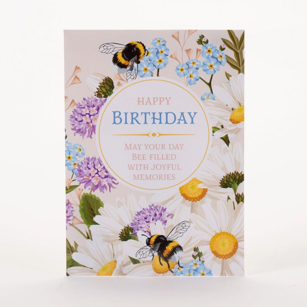 Birthday seed packet with bees and flowers on a white background