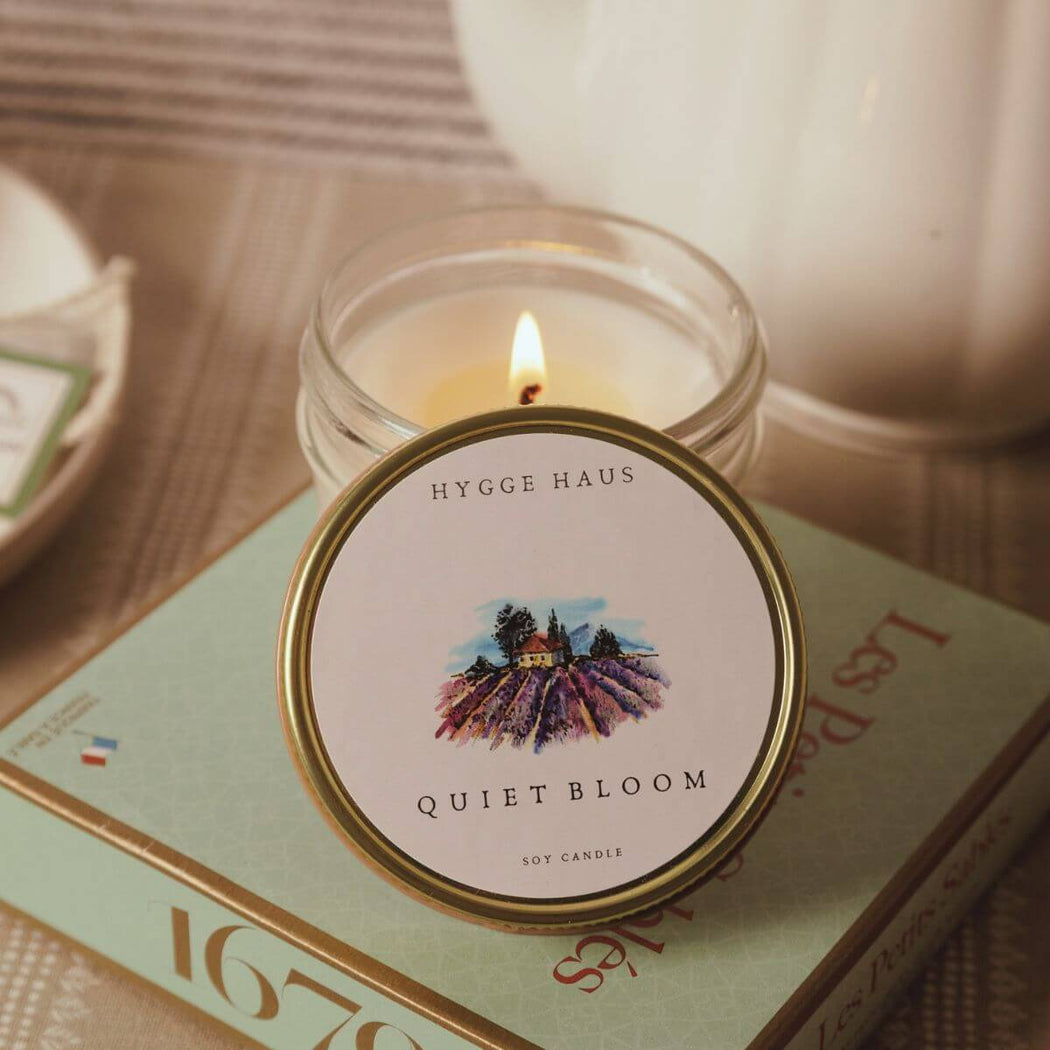 Candle with 'Hygge Haus' label on a book