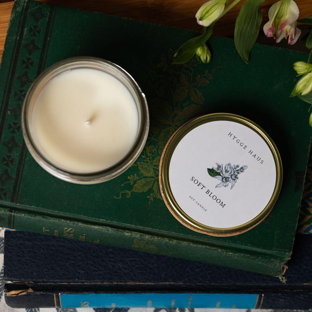 Candle in a glass jar on top of a green book
