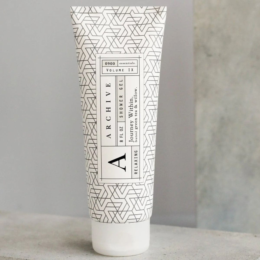Tube of Archive shower gel with geometric pattern on a neutral background