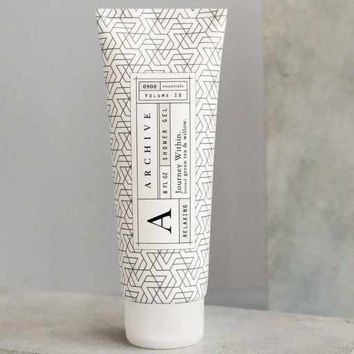 Tube of Archive shower gel with geometric pattern on a neutral background
