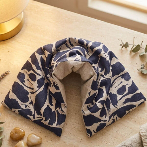 Navy blue and beige patterned towel on a wooden surface with decorative elements.