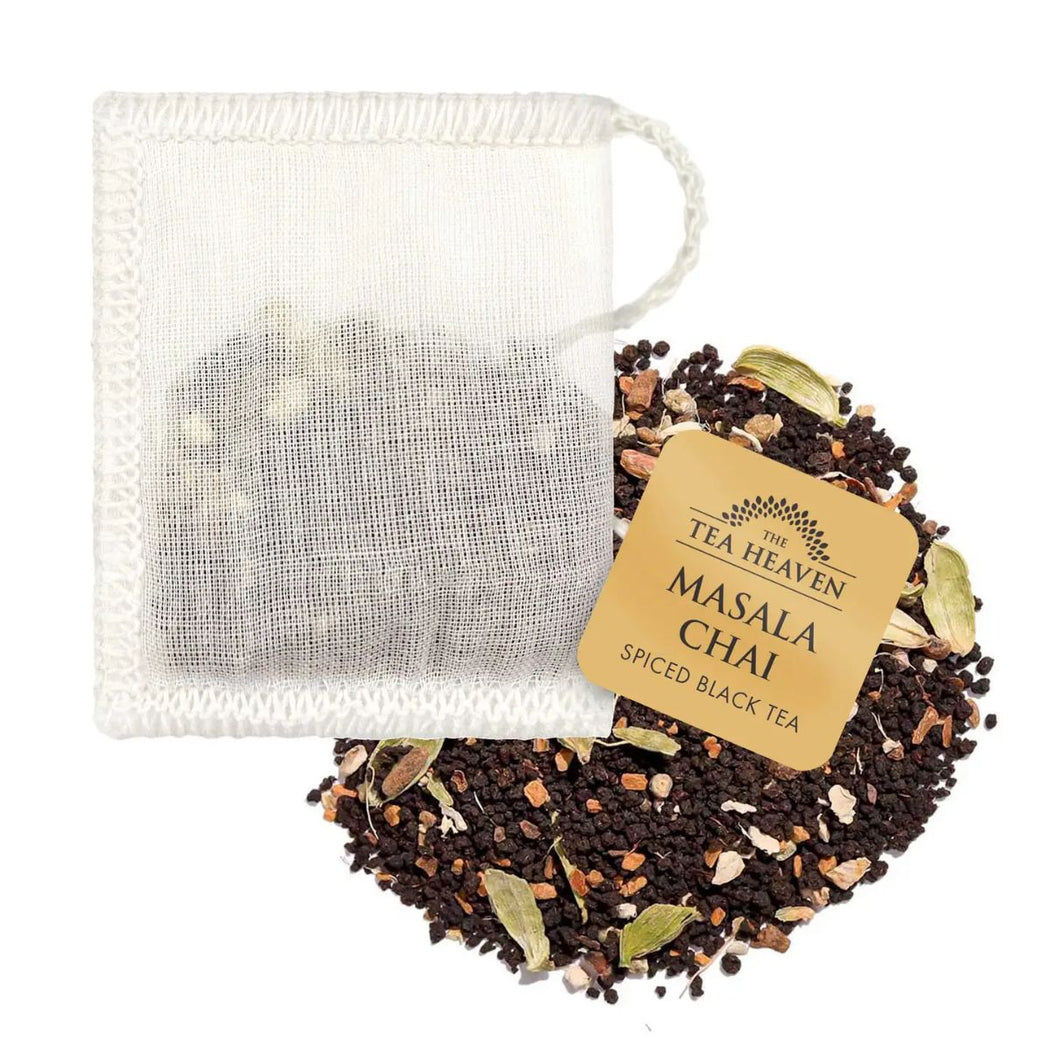 Tea bag with 'The Tea Heaven' label and Masala Chai spiced black tea leaves on a white background