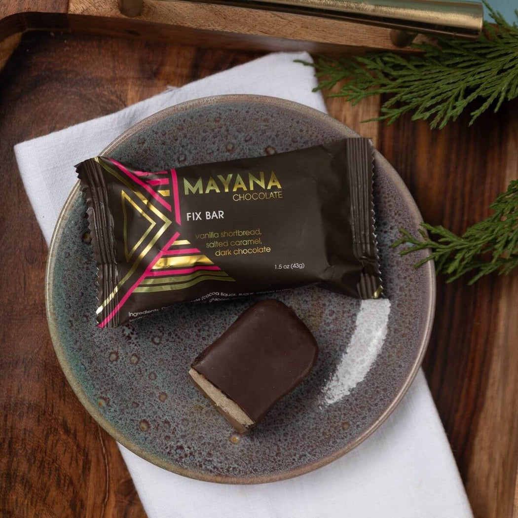 Mayana Chocolate Mini Fix Bar on a plate with a wooden background