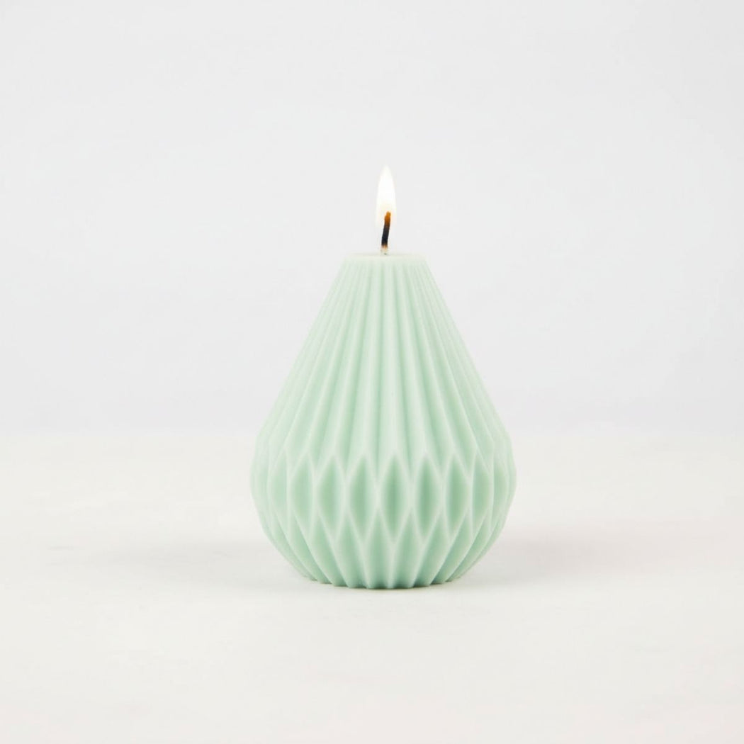 Green textured candle on a white background