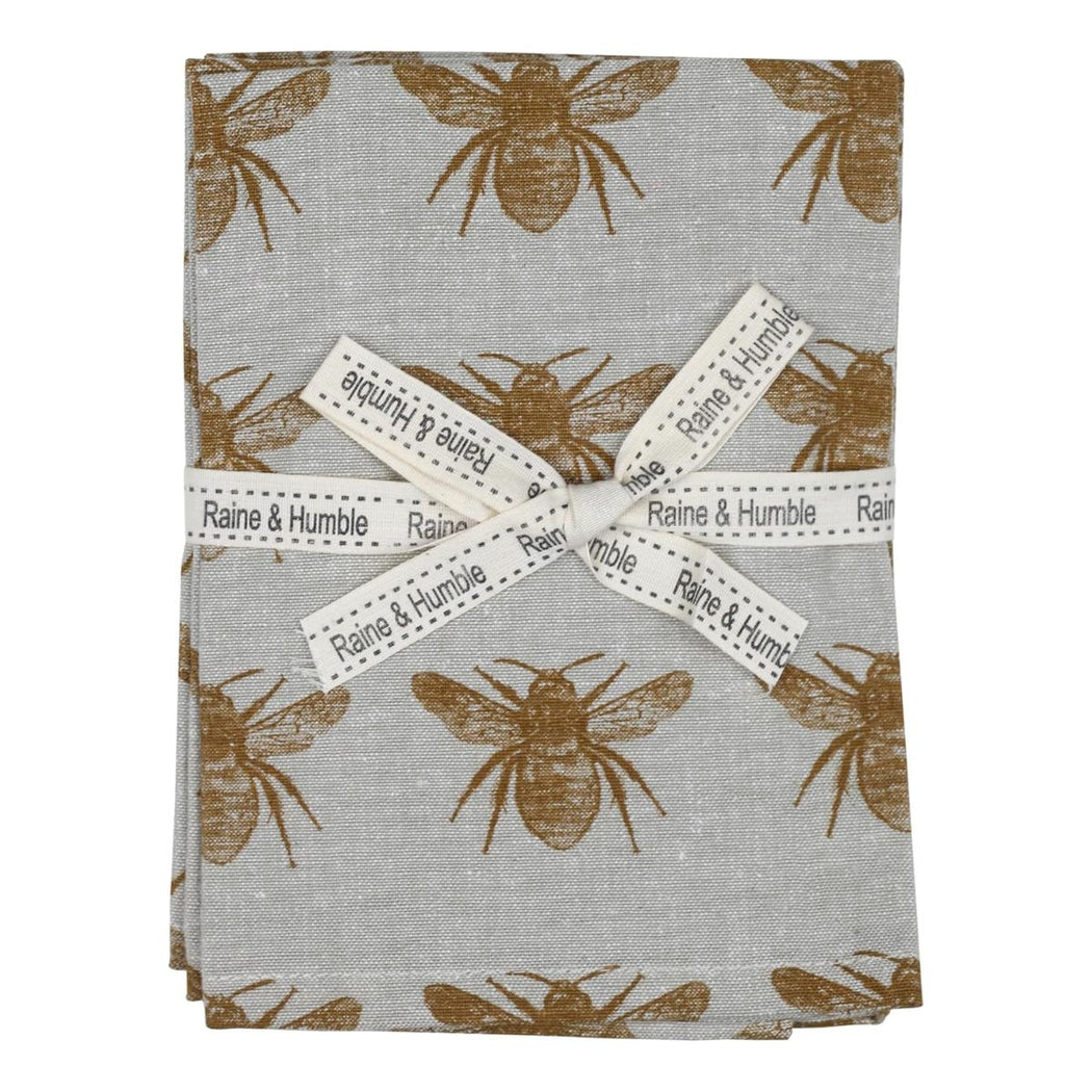 Packaged product with bee pattern and 'Raine & Humble' labels on a white background