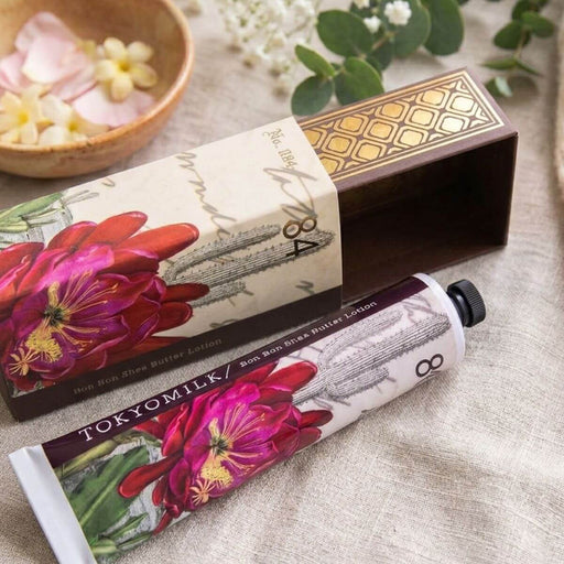 TOKYOMILK hand lotion with floral design on a textured surface