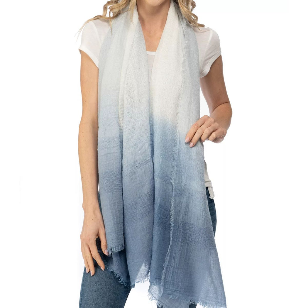 Woman wearing a blue and white gradient scarf on a white background