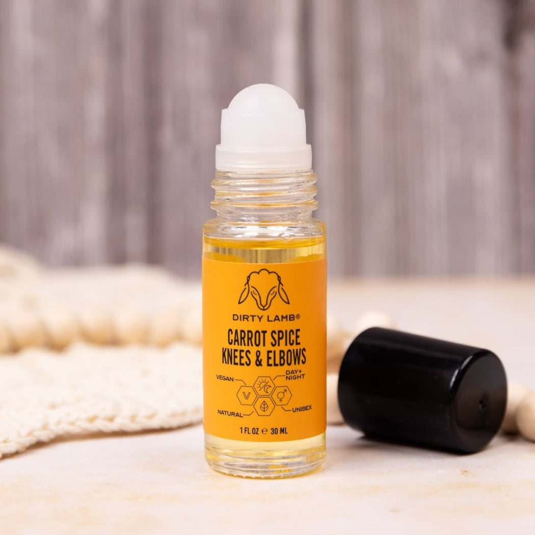 Small glass bottle of carrot spice knees and elbows serum with a black top.