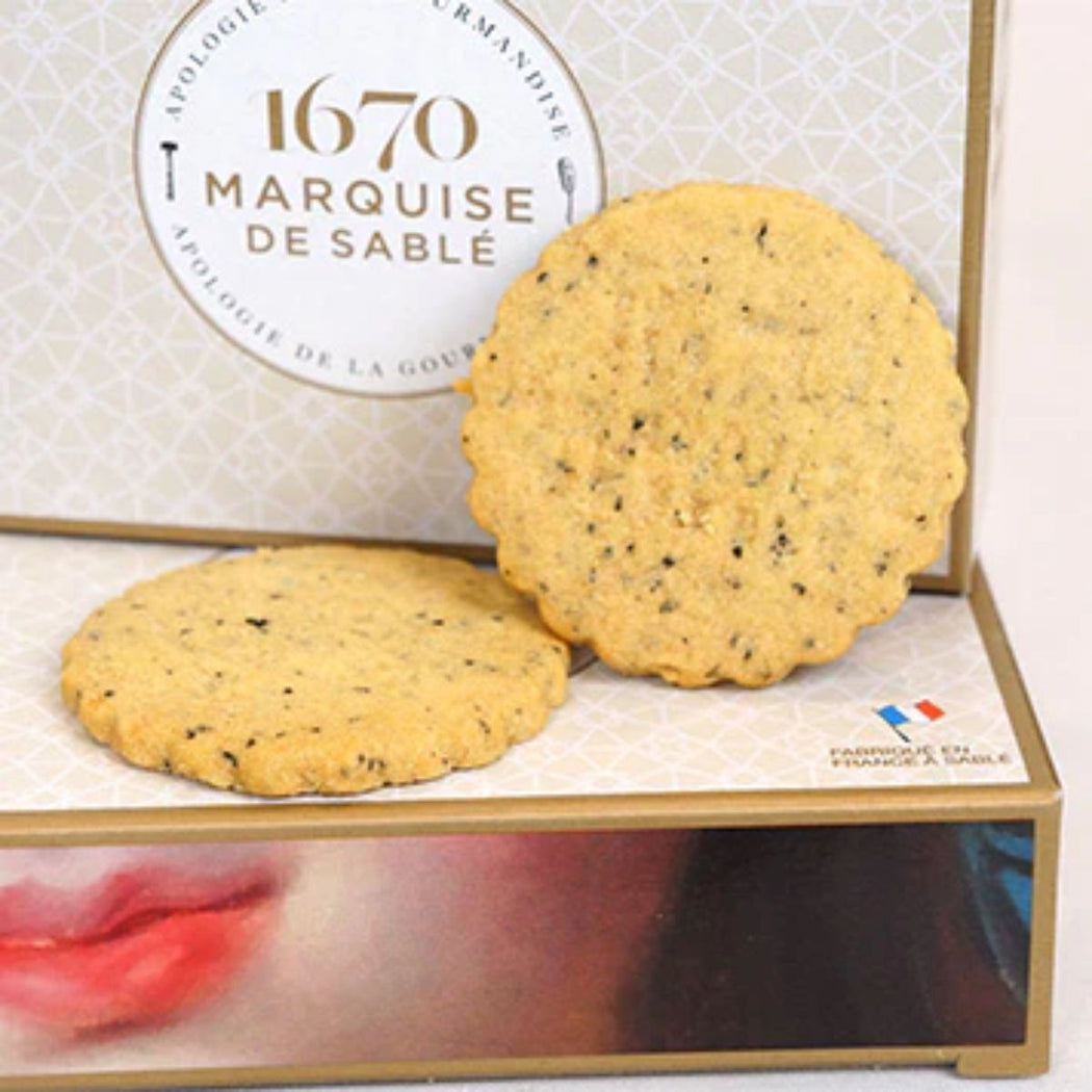 Two cookies on a box with '1670 Marquise de Sablé' branding.